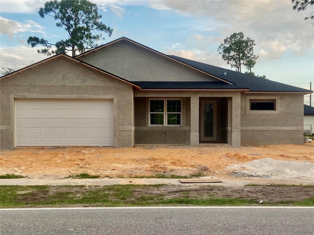 4449 Schumacher Rd, Sebring, FL 33872 - ranch-style house featuring stucco siding, a garage, and driveway