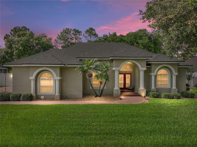 148 Melissa Trl, Auburndale, FL 33823 - mediterranean / spanish-style home featuring french doors, stucco siding, a shingled roof, and a front yard
