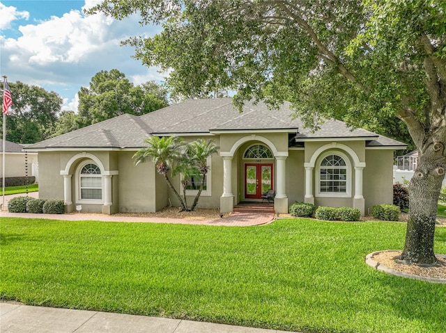 148 Melissa Trl, Auburndale, FL 33823 - mediterranean / spanish house with french doors, a shingled roof, stucco siding, and a front yard