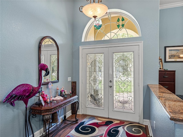 148 Melissa Trl, Auburndale, FL 33823 - foyer with french doors, wood finished floors, baseboards, and crown molding