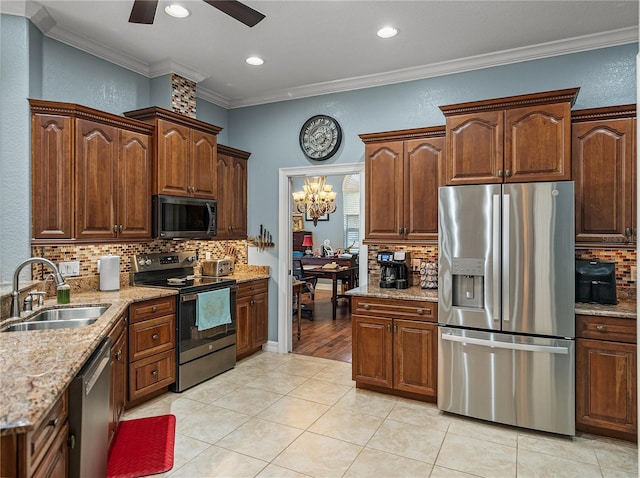 148 Melissa Trl, Auburndale, FL 33823 - kitchen with stainless steel appliances, a sink, crown molding, tasteful backsplash, and a textured wall