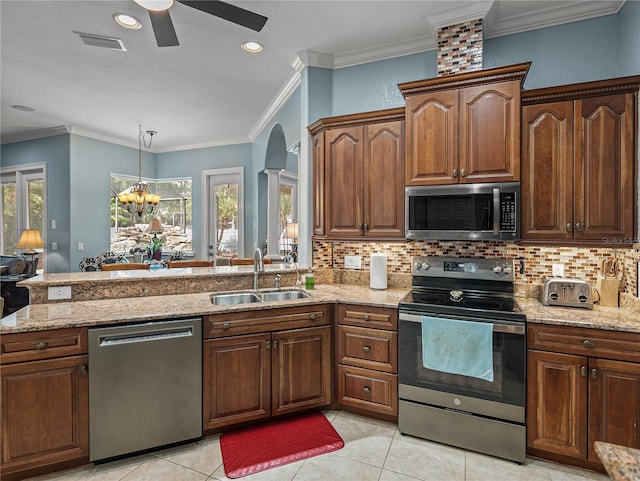 148 Melissa Trl, Auburndale, FL 33823 - kitchen featuring stainless steel appliances, a sink, a ceiling fan, a peninsula, and light stone countertops