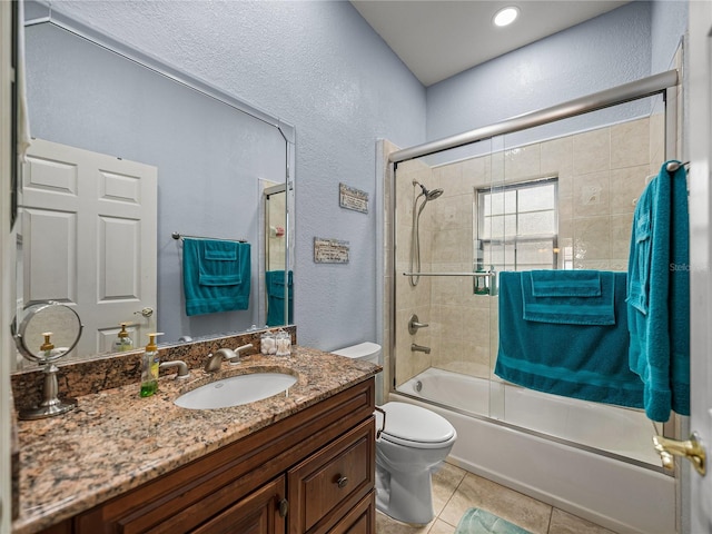148 Melissa Trl, Auburndale, FL 33823 - bathroom with a textured wall, toilet, vanity, enclosed tub / shower combo, and tile patterned flooring