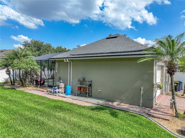 148 Melissa Trl, Auburndale, FL 33823 - back of house with stucco siding, a patio, a shingled roof, a yard, and glass enclosure