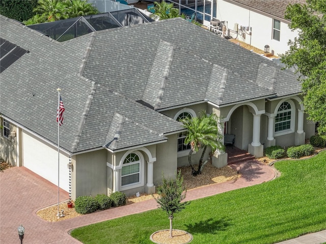 148 Melissa Trl, Auburndale, FL 33823 - view of front of house with stucco siding, roof with shingles, a front yard, and driveway