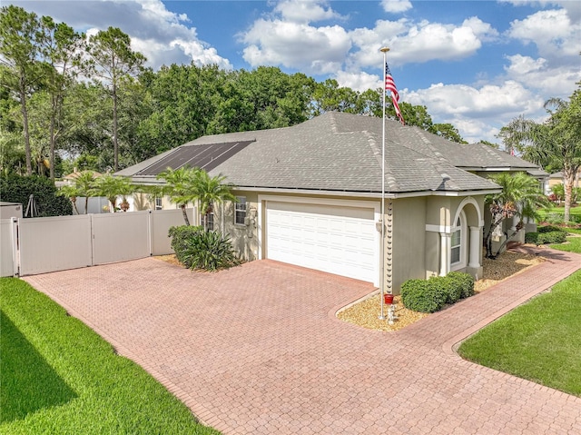 148 Melissa Trl, Auburndale, FL 33823 - view of front of house with stucco siding, a garage, a gate, decorative driveway, and a shingled roof