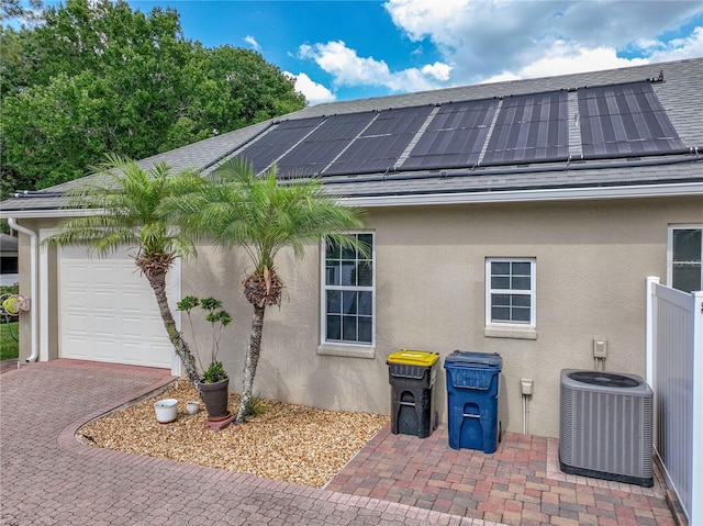 148 Melissa Trl, Auburndale, FL 33823 - view of home's exterior featuring central AC, stucco siding, and a garage