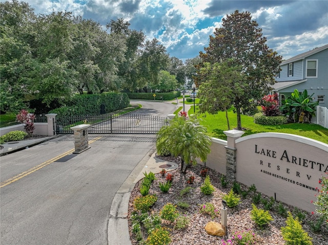 148 Melissa Trl, Auburndale, FL 33823 - view of asphalt road featuring a gate, a gated entry, and curbs