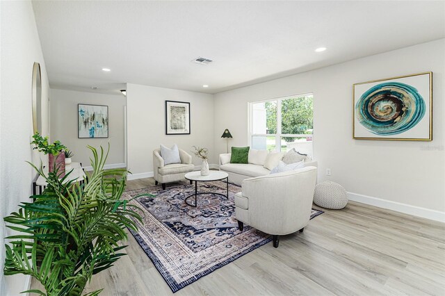 6338 Oak Sq E, Lakeland, FL 33813 - living room featuring wood finished floors, baseboards, and recessed lighting