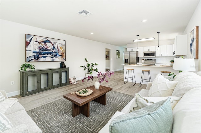 6338 Oak Sq E, Lakeland, FL 33813 - living area with light wood-style floors, baseboards, and recessed lighting
