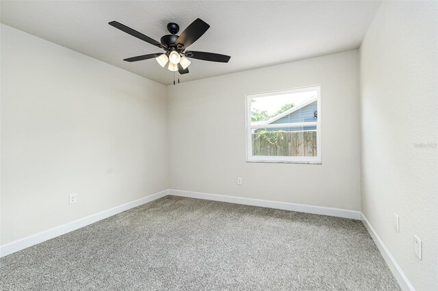 6338 Oak Sq E, Lakeland, FL 33813 - carpeted spare room with baseboards and a ceiling fan