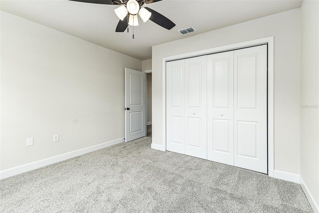 6338 Oak Sq E, Lakeland, FL 33813 - unfurnished bedroom with carpet floors, baseboards, a closet, and ceiling fan