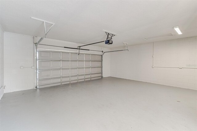 6338 Oak Sq E, Lakeland, FL 33813 - garage with concrete block wall and a garage door opener