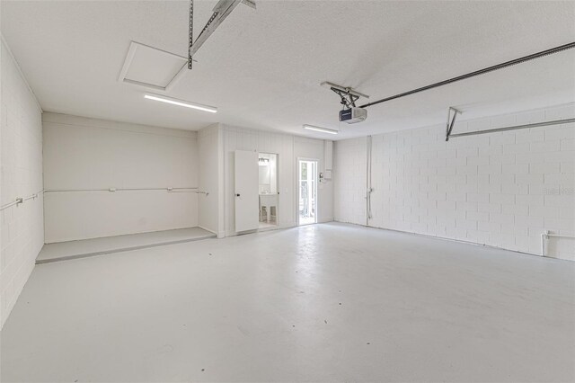6338 Oak Sq E, Lakeland, FL 33813 - garage with a garage door opener and concrete block wall