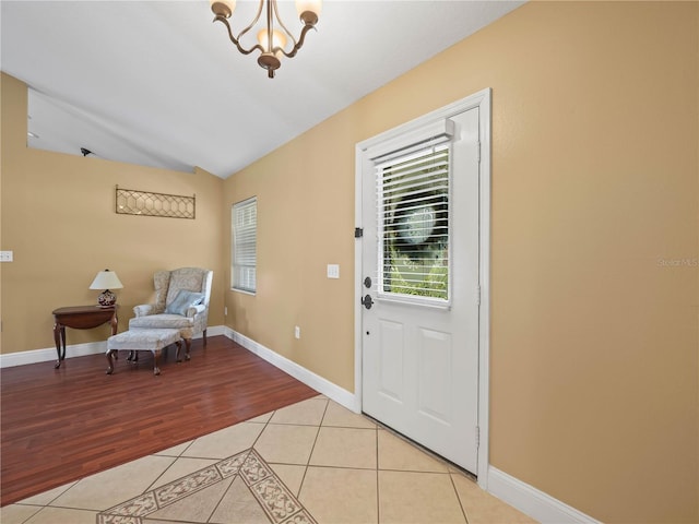 2921 W Socrum Loop Rd, Lakeland, FL 33810 - foyer entrance with a chandelier, light tile patterned flooring, vaulted ceiling, and baseboards