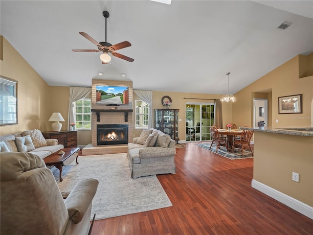 2921 W Socrum Loop Rd, Lakeland, FL 33810 - living room featuring vaulted ceiling, wood finished floors, a fireplace, ceiling fan, and baseboards