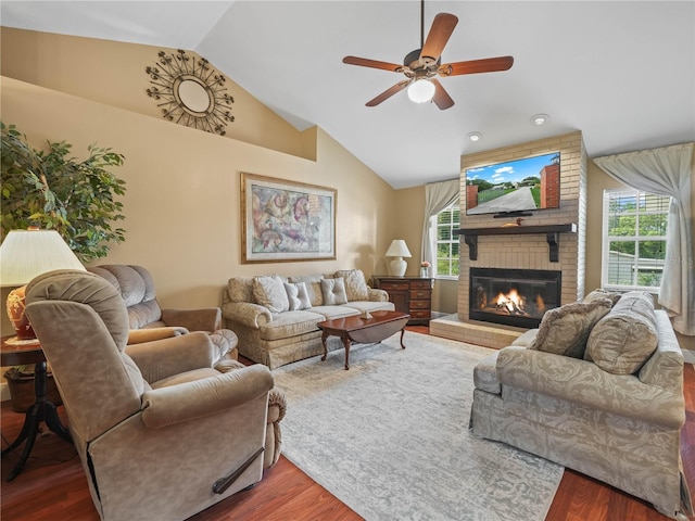 2921 W Socrum Loop Rd, Lakeland, FL 33810 - living room with lofted ceiling, wood finished floors, a fireplace, and plenty of natural light