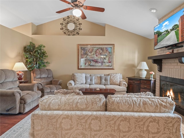 2921 W Socrum Loop Rd, Lakeland, FL 33810 - living room featuring vaulted ceiling, wood finished floors, ceiling fan, and a fireplace