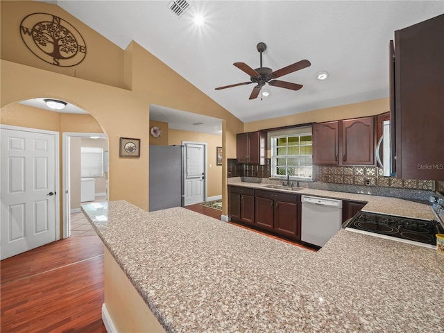 2921 W Socrum Loop Rd, Lakeland, FL 33810 - kitchen featuring stainless steel appliances, a sink, arched walkways, a ceiling fan, and backsplash