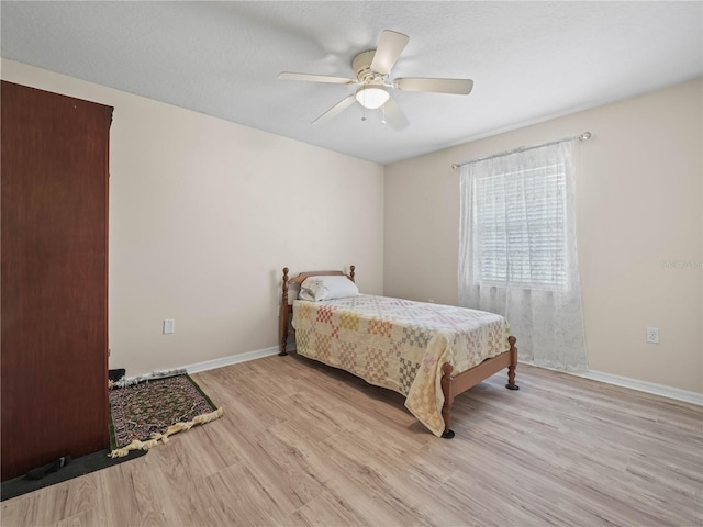 2921 W Socrum Loop Rd, Lakeland, FL 33810 - bedroom with light wood-style flooring, baseboards, and a ceiling fan