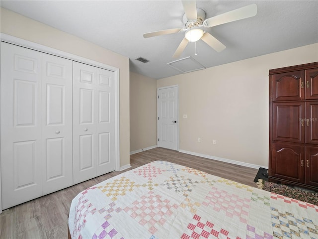 2921 W Socrum Loop Rd, Lakeland, FL 33810 - bedroom featuring light wood-style flooring, baseboards, a closet, and attic access