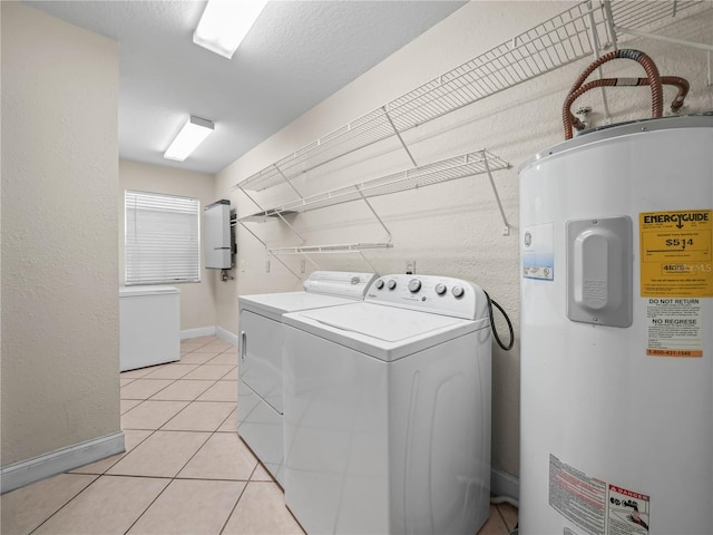 2921 W Socrum Loop Rd, Lakeland, FL 33810 - washroom with water heater, independent washer and dryer, light tile patterned floors, and baseboards