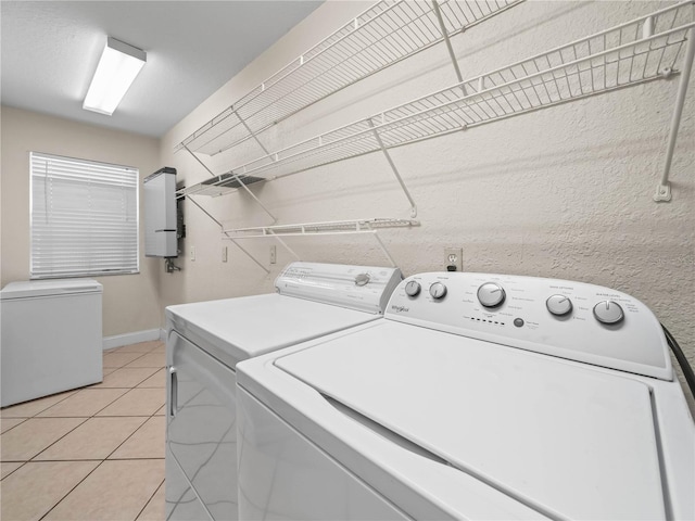 2921 W Socrum Loop Rd, Lakeland, FL 33810 - laundry area featuring washer and dryer, light tile patterned floors, and baseboards