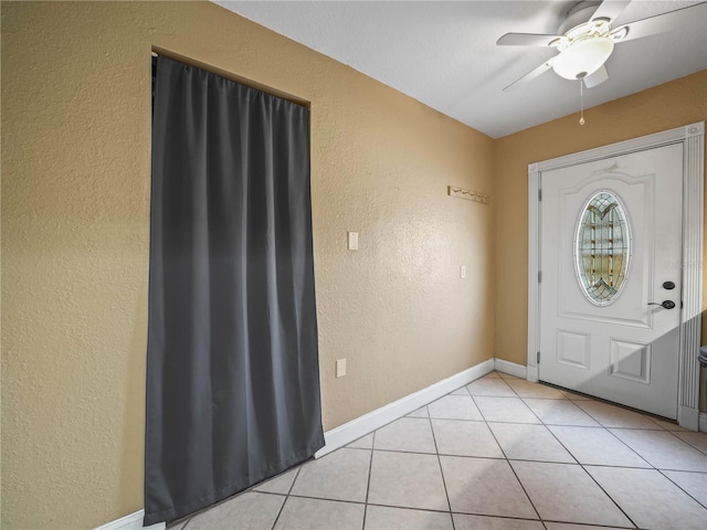 2921 W Socrum Loop Rd, Lakeland, FL 33810 - foyer with a textured wall, a ceiling fan, light tile patterned floors, and baseboards