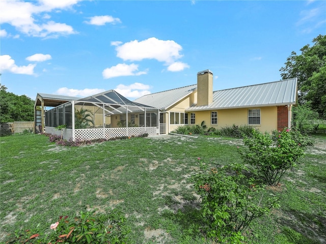 2921 W Socrum Loop Rd, Lakeland, FL 33810 - rear view of property with a chimney, metal roof, and stucco siding