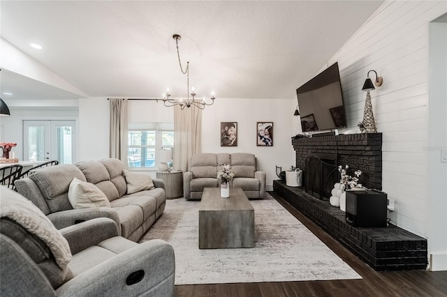 7608 Franklin Rd, Plant City, FL 33565 - living room with lofted ceiling, wood finished floors, a chandelier, and a fireplace