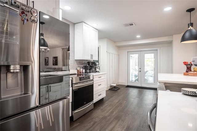 7608 Franklin Rd, Plant City, FL 33565 - kitchen featuring stainless steel appliances, french doors, white cabinetry, dark wood-style floors, and light countertops