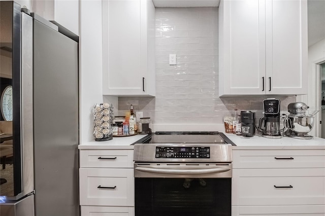 7608 Franklin Rd, Plant City, FL 33565 - kitchen featuring stainless steel appliances, light countertops, decorative backsplash, and white cabinetry