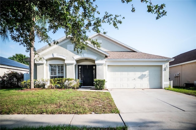 11567 Misty Isle Ln, Riverview, FL 33579 - ranch-style house featuring stucco siding, an attached garage, driveway, and a front yard