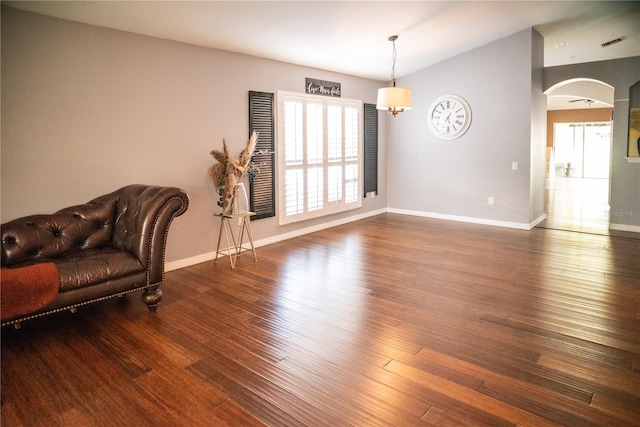 11567 Misty Isle Ln, Riverview, FL 33579 - living area featuring arched walkways, wood finished floors, lofted ceiling, and baseboards