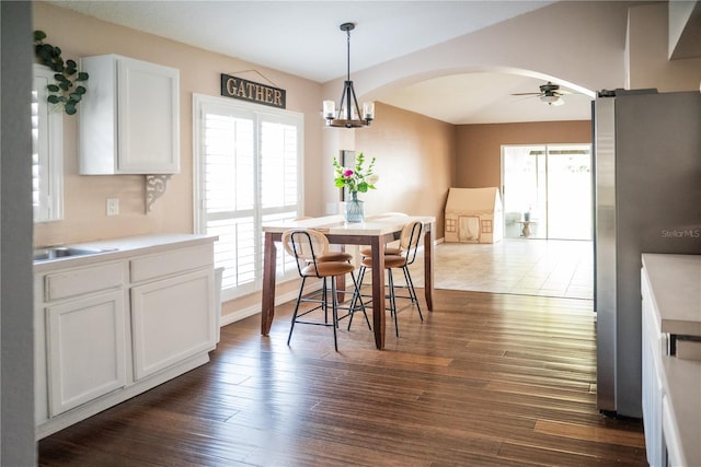 11567 Misty Isle Ln, Riverview, FL 33579 - dining room with healthy amount of natural light, ceiling fan, arched walkways, and dark wood-style flooring