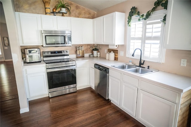 11567 Misty Isle Ln, Riverview, FL 33579 - kitchen featuring stainless steel appliances, a sink, vaulted ceiling, light countertops, and white cabinetry