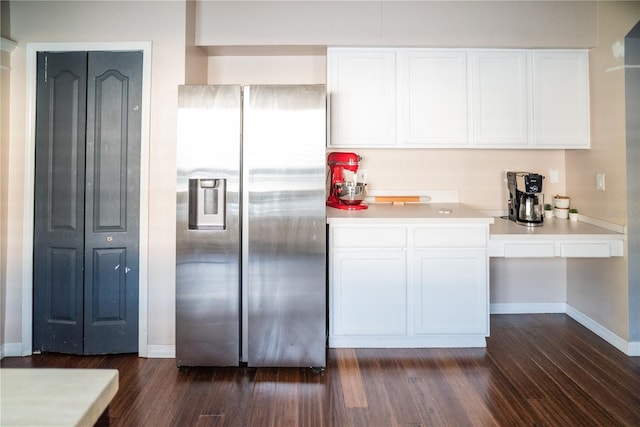 11567 Misty Isle Ln, Riverview, FL 33579 - kitchen featuring stainless steel refrigerator with ice dispenser, white cabinetry, dark wood-style floors, and baseboards
