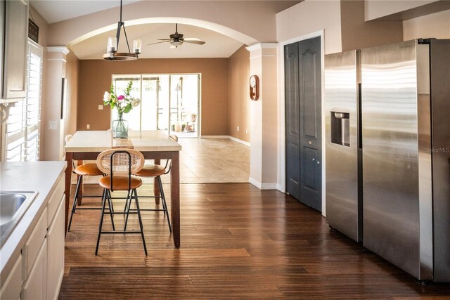 11567 Misty Isle Ln, Riverview, FL 33579 - dining space with arched walkways, dark wood-style floors, ceiling fan, and baseboards