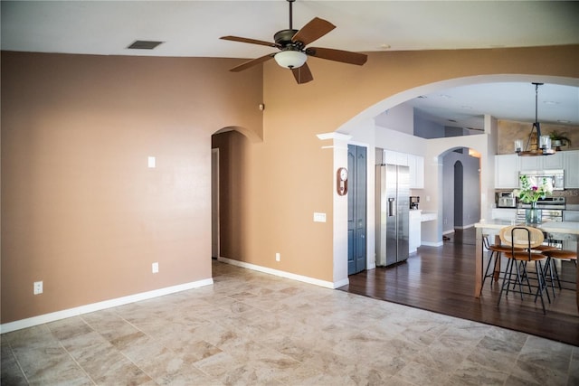 11567 Misty Isle Ln, Riverview, FL 33579 - living area featuring a ceiling fan, high vaulted ceiling, arched walkways, and baseboards