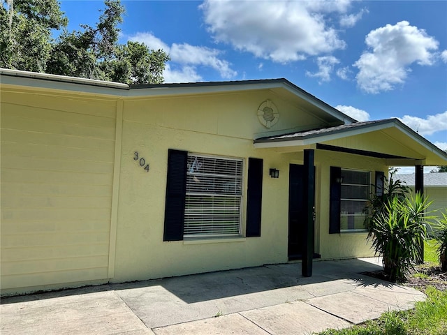 304 Bell St, Wauchula, FL 33873 - view of exterior entry featuring a patio area and stucco siding