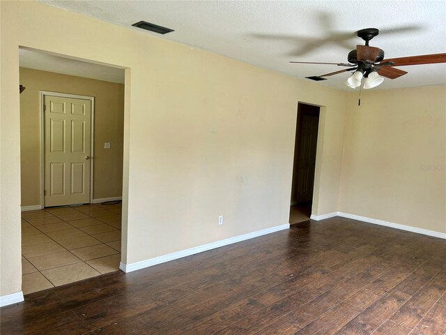 304 Bell St, Wauchula, FL 33873 - spare room featuring a ceiling fan, wood finished floors, and baseboards