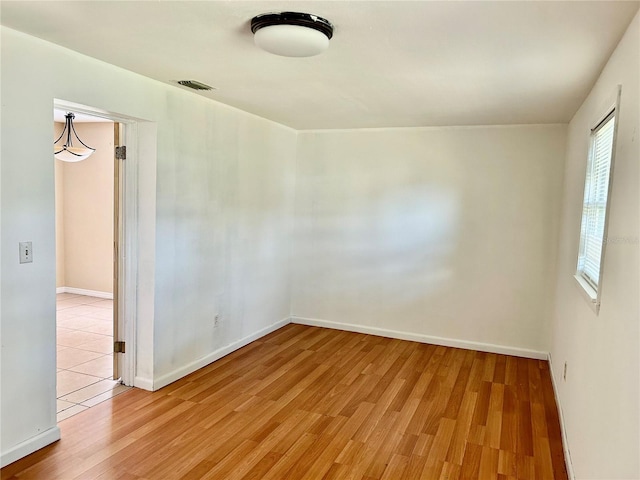 304 Bell St, Wauchula, FL 33873 - empty room with wood finished floors and baseboards