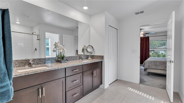 2966 Flying Blackbird Rd, Bartow, FL 33830 - bathroom with baseboards, double vanity, tile patterned flooring, ensuite bathroom, and a tile shower