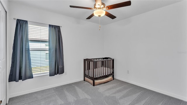 2966 Flying Blackbird Rd, Bartow, FL 33830 - unfurnished bedroom featuring carpet flooring, baseboards, a crib, and ceiling fan