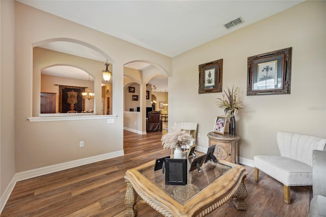 6339 Alamanda Hills Dr, Lakeland, FL 33813 - living area with wood finished floors, a chandelier, baseboards, and arched walkways