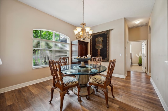 6339 Alamanda Hills Dr, Lakeland, FL 33813 - dining space featuring a chandelier, wood finished floors, and baseboards