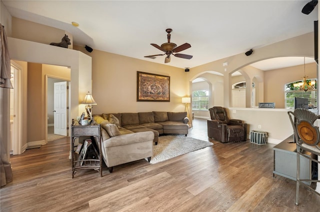 6339 Alamanda Hills Dr, Lakeland, FL 33813 - living room featuring wood finished floors, arched walkways, healthy amount of natural light, and a ceiling fan