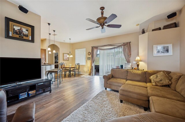 6339 Alamanda Hills Dr, Lakeland, FL 33813 - living area with wood finished floors, a ceiling fan, baseboards, and arched walkways
