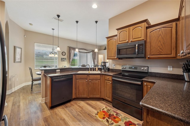 6339 Alamanda Hills Dr, Lakeland, FL 33813 - kitchen with dishwashing machine, stainless steel electric stove, a peninsula, a sink, and dark countertops