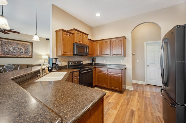 6339 Alamanda Hills Dr, Lakeland, FL 33813 - kitchen featuring black / electric stove, freestanding refrigerator, a sink, dark countertops, and recessed lighting
